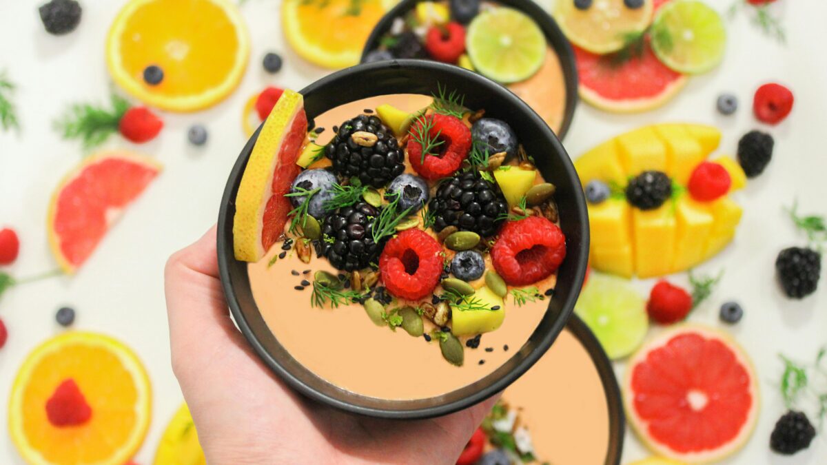 Colorful bowl of fresh fruits with a mix of berries and seeds, perfect for a healthy meal.