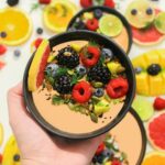 Colorful bowl of fresh fruits with a mix of berries and seeds, perfect for a healthy meal.