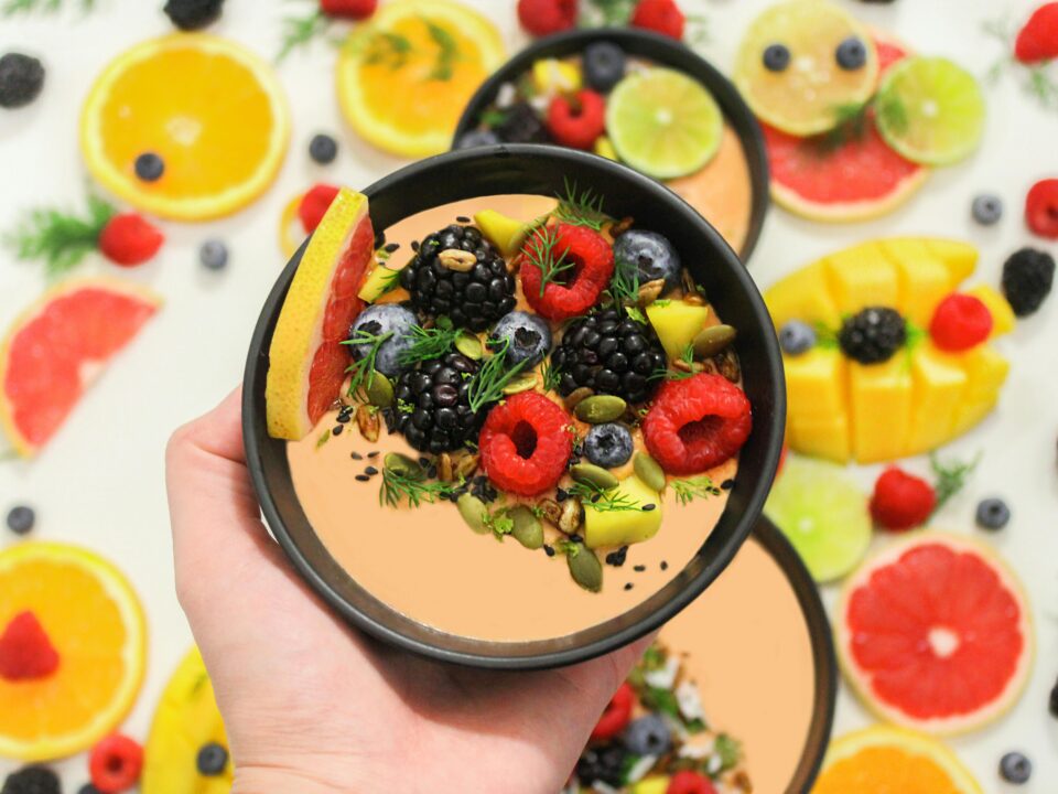 Colorful bowl of fresh fruits with a mix of berries and seeds, perfect for a healthy meal.