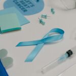 Blue ribbon with medical supplies symbolizes healthcare awareness and cancer support.
